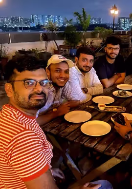 Alchemy Tech team members having dinner together on a rooftop