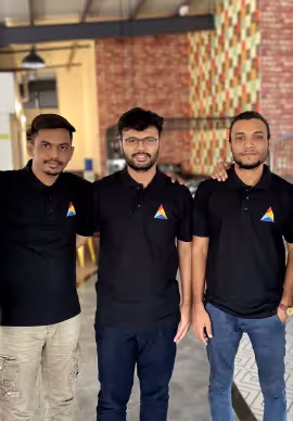 Alchemy Tech team members posing together in branded polo shirts