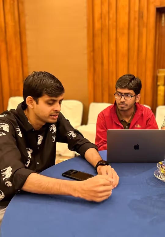 Alchemy Tech team members working together on a laptop