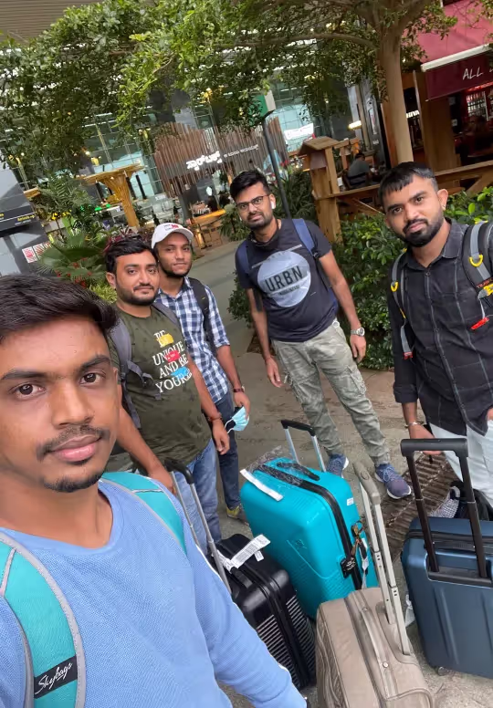 Alchemy Tech team members with luggage heading on a team trip